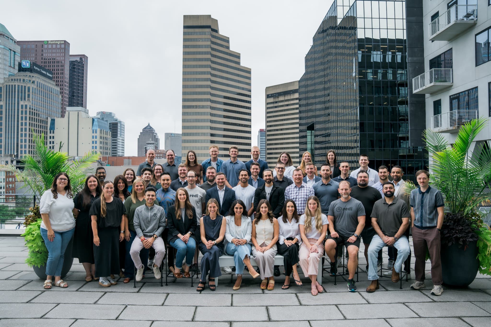 The Redi Health team gathered on a rooftop overlooking downtown Columbus